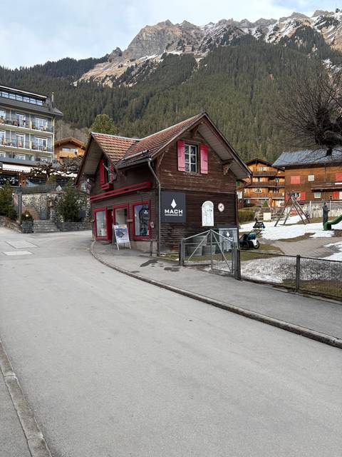 Rustic wooden building in a mountainous setting.