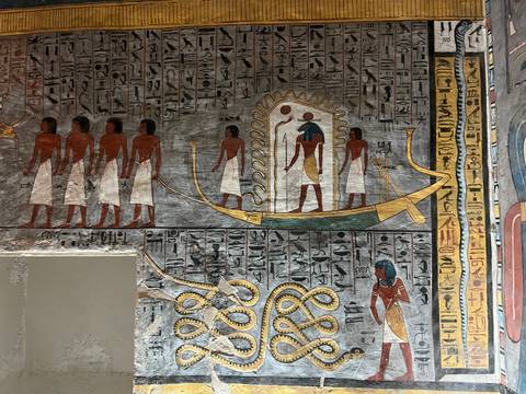 Colorful ancient Egyptian wall art and hieroglyphs.