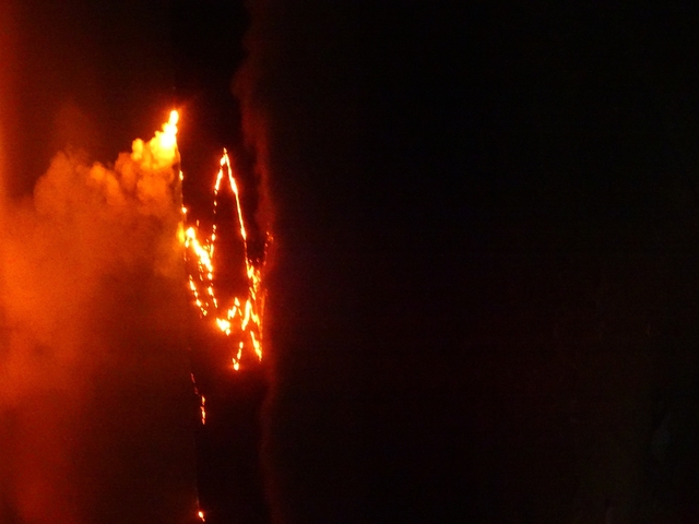 Lava flowing at night from a volcano.