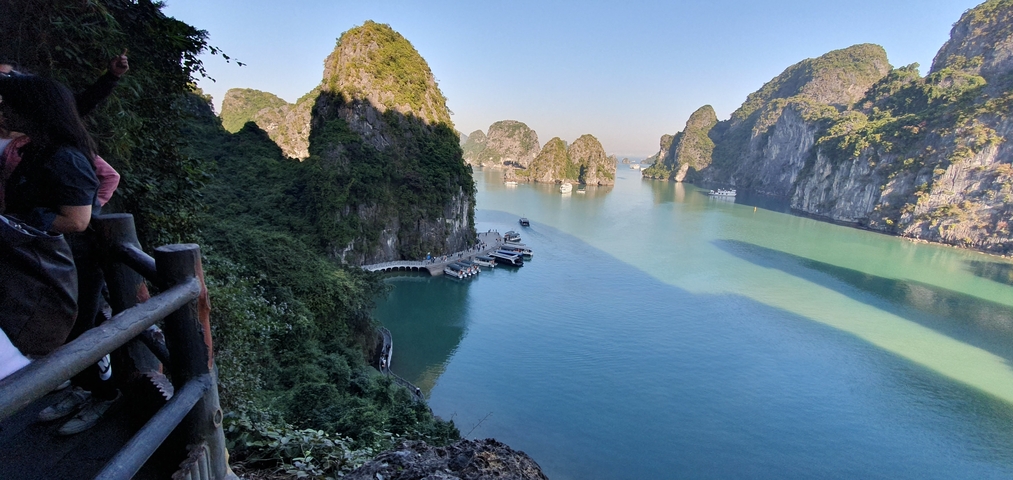 Aerial view of Halong Bay's limestone islands and teal water.