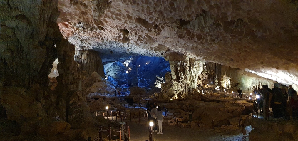 Large cave interior with illuminated pathways.