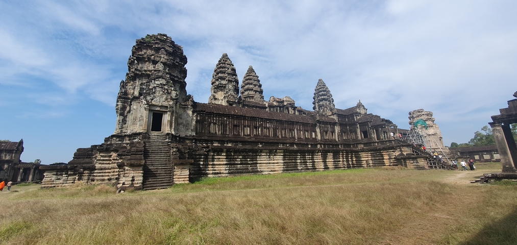 Majestic temple with ancient architecture under a blue sky.