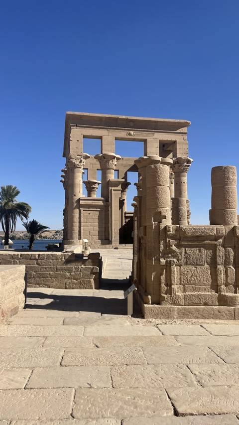 Philae Temple columns with a view of the Nile river.