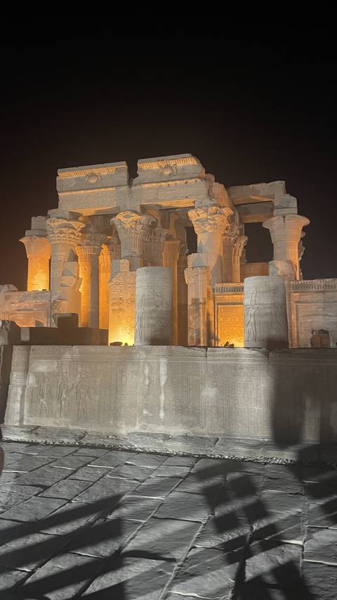 Ancient Egyptian columns illuminated at night.