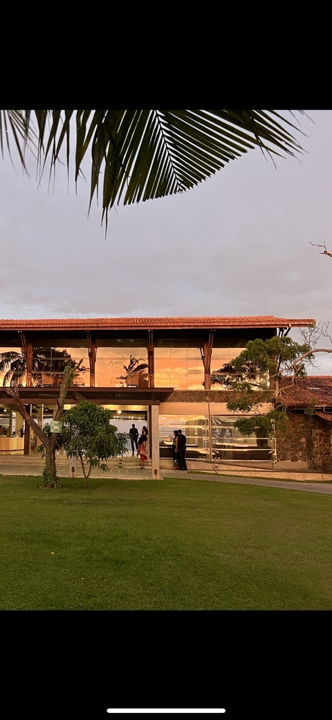 Modern building with glass windows reflecting the sunset.