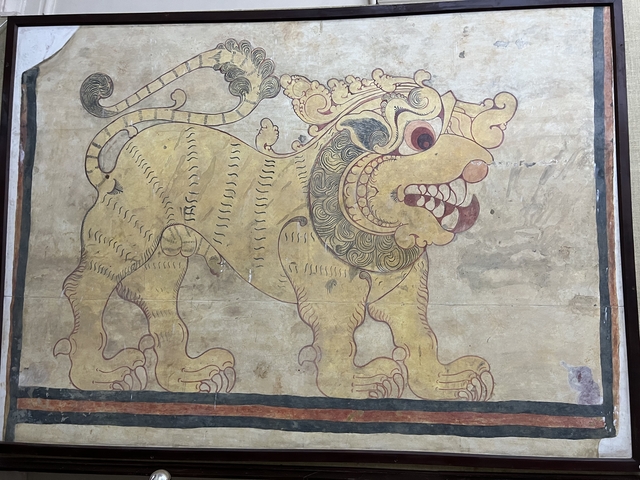 Ancient drawing of a mythical creature on a wall.