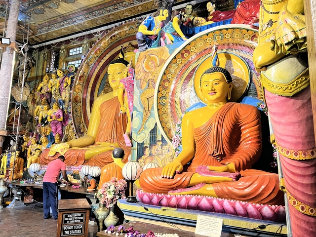 Colorful, intricate Buddha shrine with multiple figures.