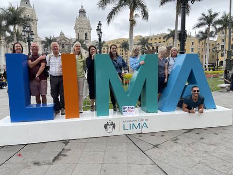 Group posing with large letters spelling 'LIMA'.