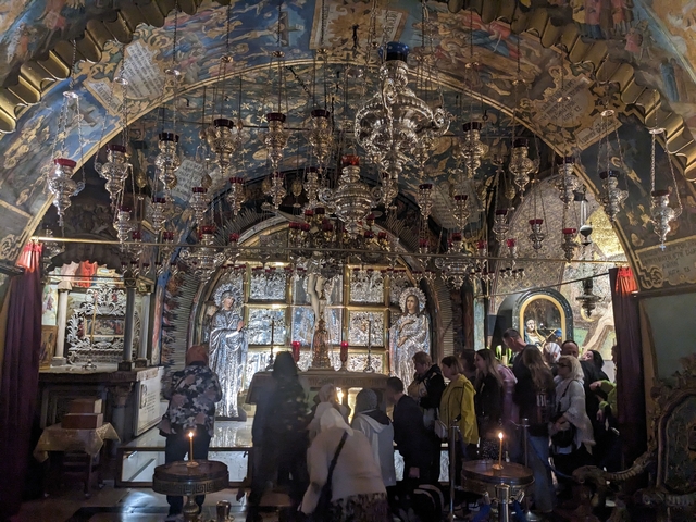 Religious site interior with people.