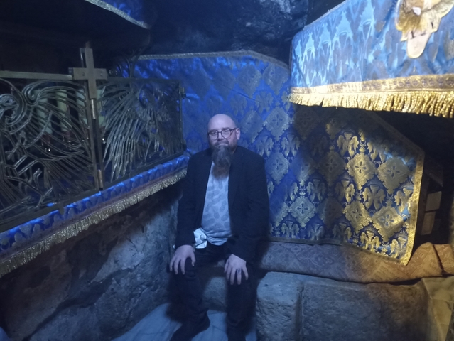Man sitting in a blue-themed interior.