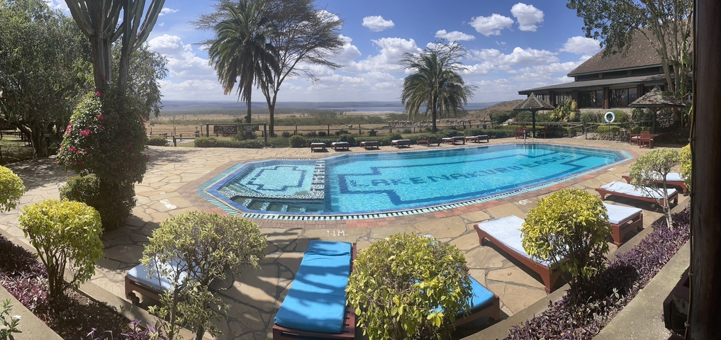 Swimming pool area with a scenic view towards mountains.