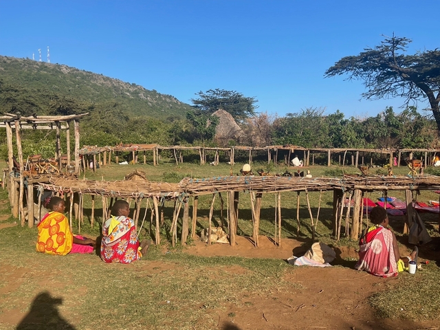 Traditional village setting with people in colorful garments.
