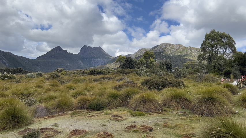 Mountain landscape with distinctive peaks and cloudy sky.