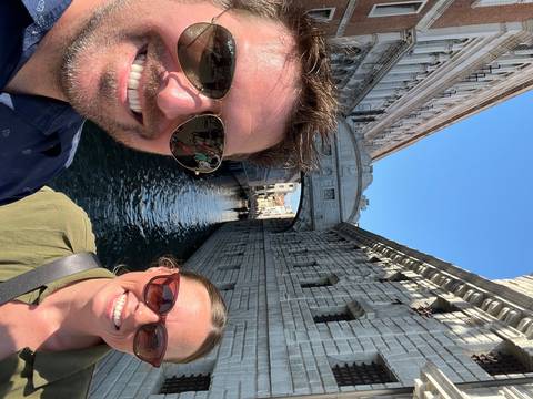 Upside-down photo of a couple in a gondola canal.