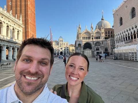 Upside-down portrait of a couple in a historic square.