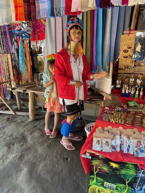 Cultural market scene with a person weaving traditional crafts.