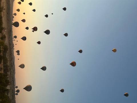 Hot air balloons in the sky at sunset.