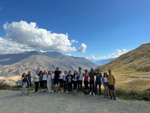 Group of people posing with mountains
