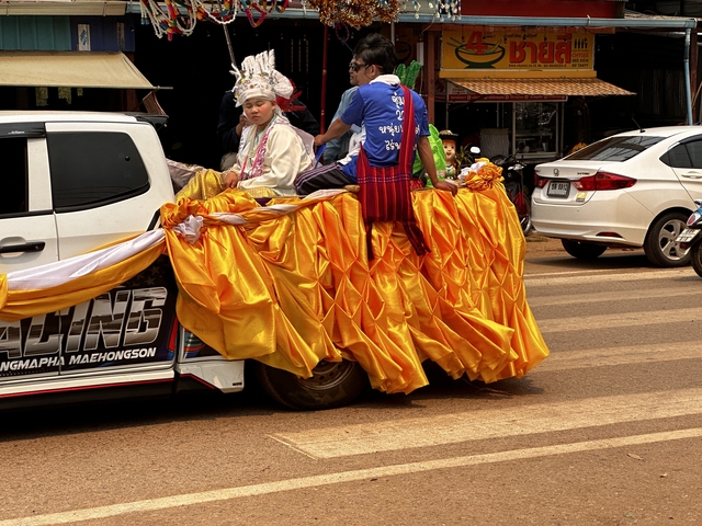 Decorative float with people in traditional attire.
