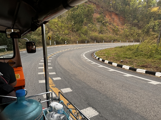 View from a vehicle on a winding road.