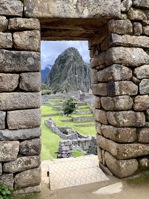 View of Machu Picchu through a stone window.