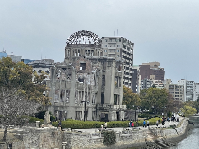 Atomic Bomb Dome in Hiroshima with city buildings in the background.