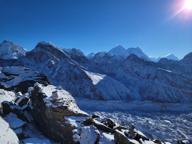 Snow-covered mountains and glacier under a clear sky.