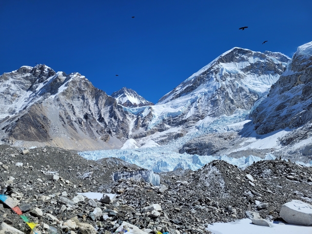 Vast snowy mountain peaks under a clear blue sky.
