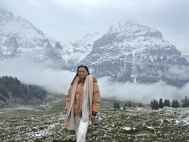 Individual posing in snowy mountain landscape.