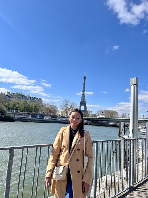 Individual posing by the Eiffel Tower.