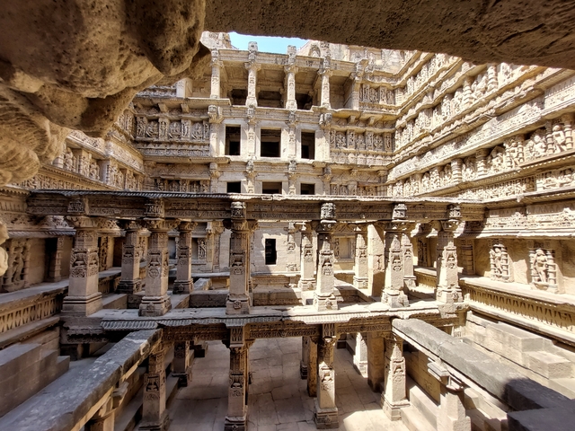 An intricately carved architectural structure with pillars.