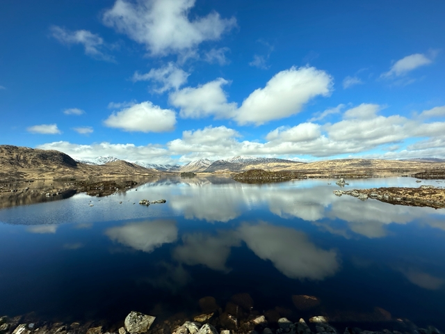 Mountainous landscape reflected in a lake.