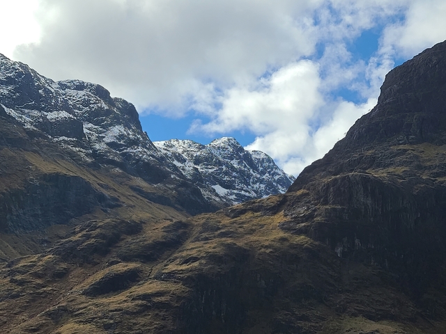Snow-capped mountains under a blue sky.
