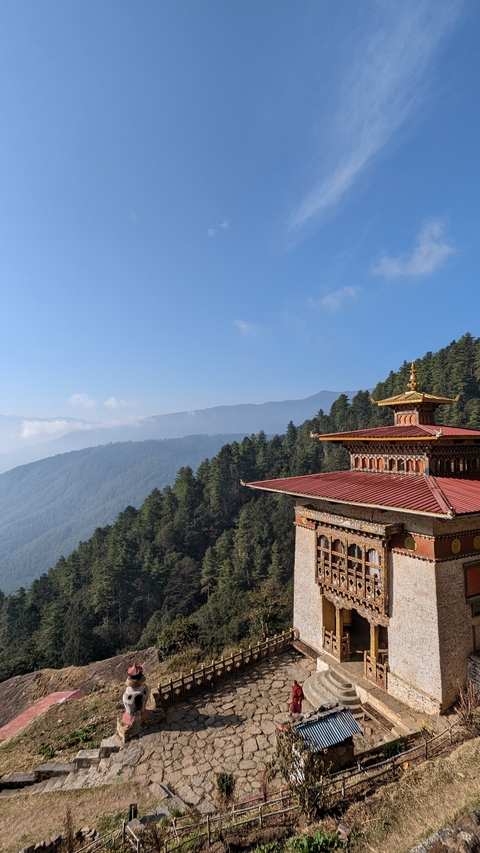 Ornate architectural structure with a scenic mountainous backdrop.