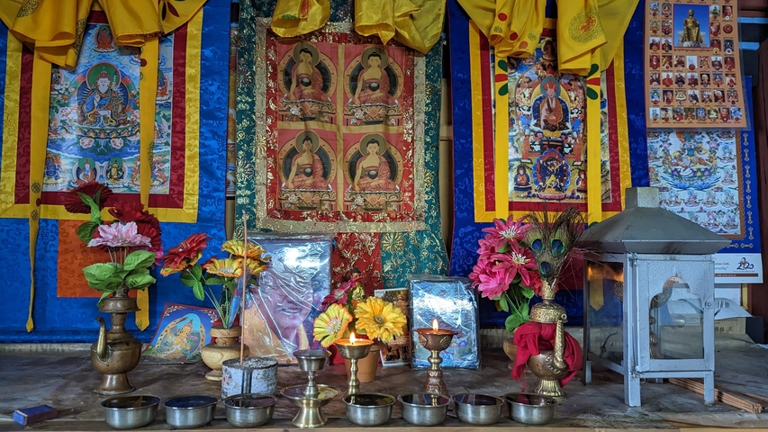 Colorful religious altars with ornaments and offerings.