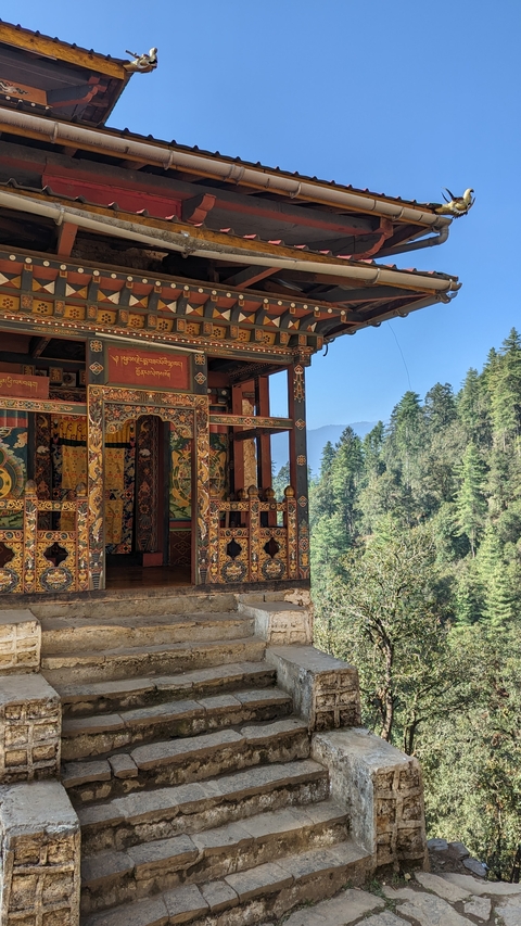 Detailed view of traditional Bhutanese architecture amidst trees.