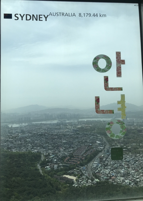 Hazy city view from a high point with a decorative window.