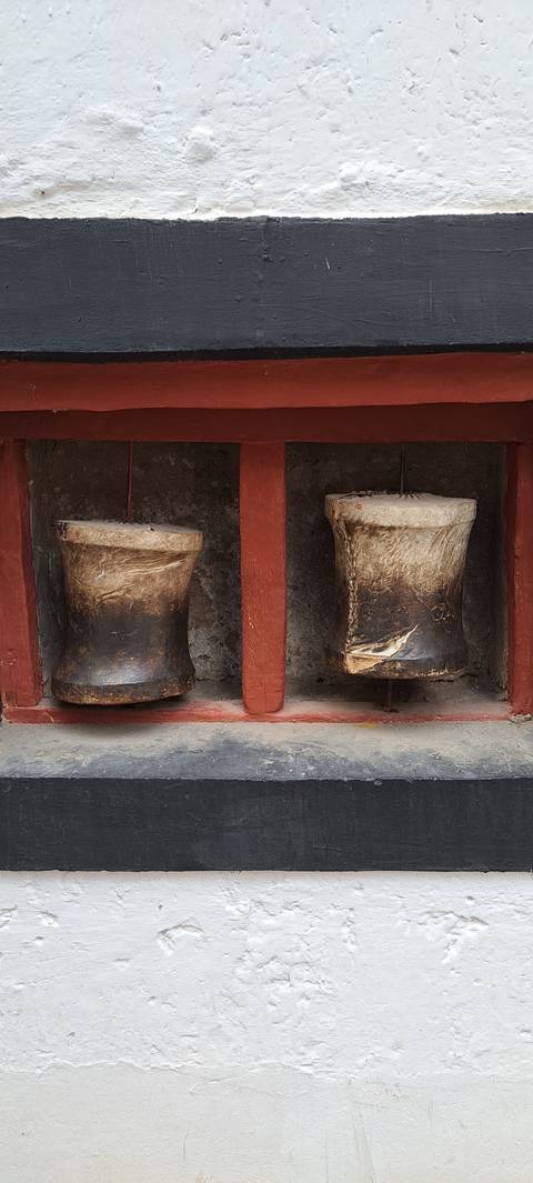 Decorative wall feature with two horn-like objects mounted.