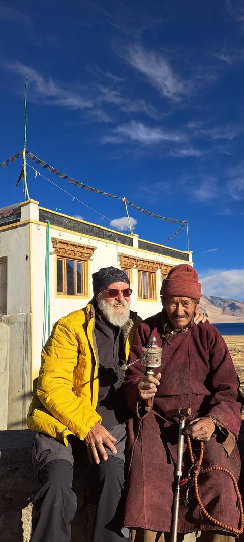 Two people posing in front of a building.