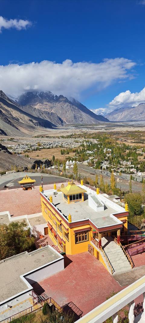 View of a colorful hillside town with a temple.
