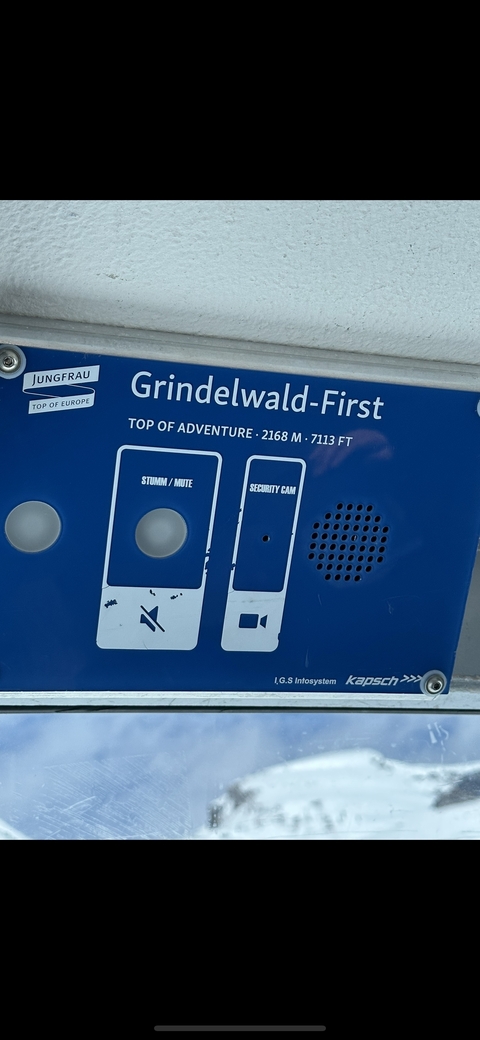 Close-up of a sign with text about Grindelwald.