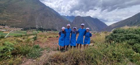 Group of people on a trail wearing blue ponchos.