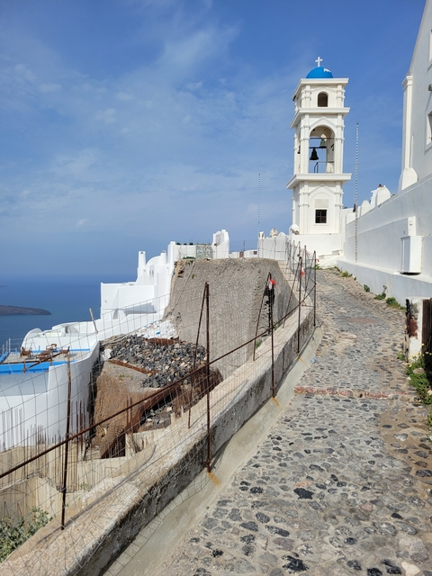 Path with white walls leading to a church