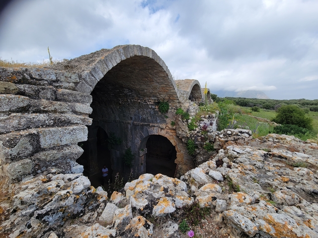 Ruins of an ancient structure in a hilly landscape