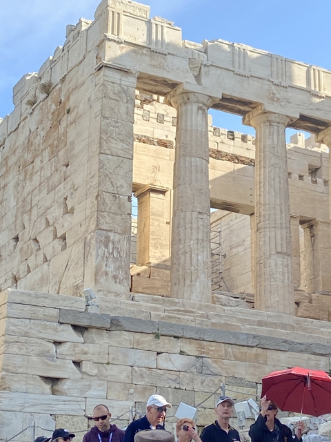 Close-up of ancient Greek columns with clear blue sky.