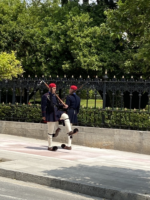 Two guards in traditional attire performing a ceremonial march.