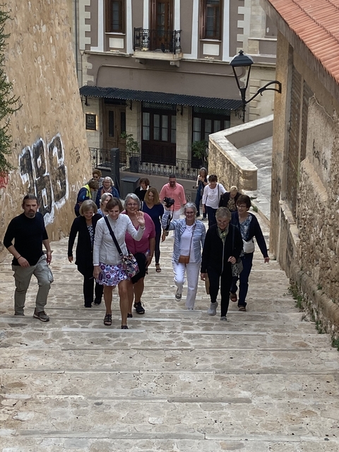 Group of people walking up a stone staircase.