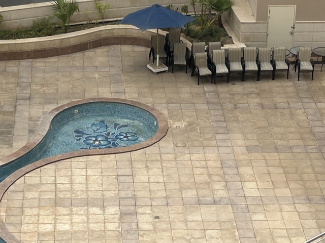 Overhead view of a small outdoor pool and seating area.