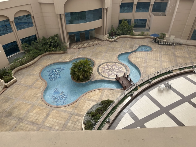 Aerial view of an artistic-shaped swimming pool.
