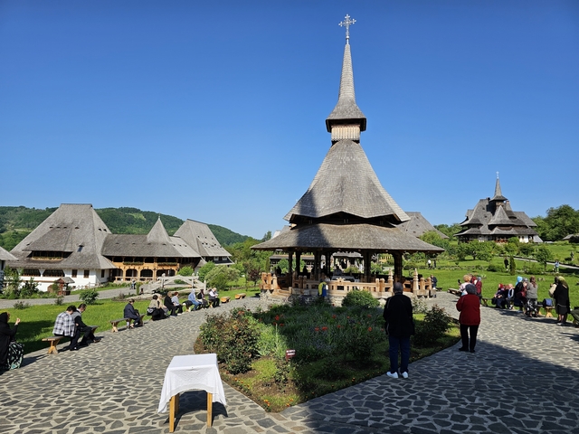 Traditional wooden church with tourists exploring.